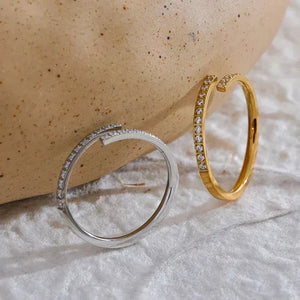 Gold and silver open rings with small crystals, minimalist jewelry on textured fabric