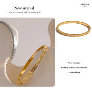 Gold bangles on a white surface with 'NEW++' branding.
