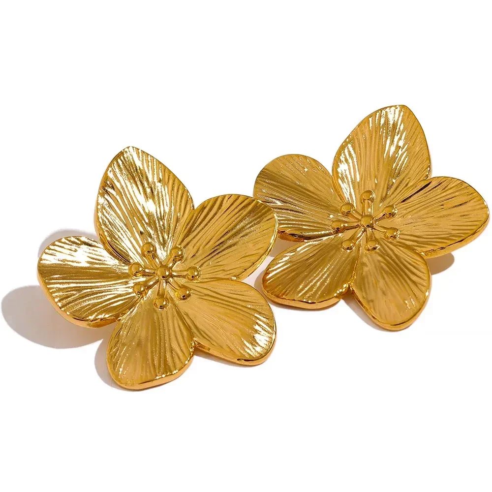 Gold-plated flower-shaped earrings with textured petal detailing on a white background