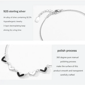 Silver bracelet with heart-shaped charms on a white background, featuring text about 925 sterling silver and polishing process.