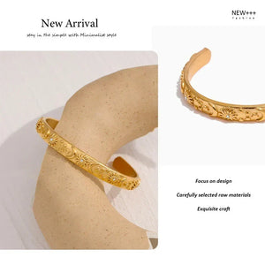 Gold bracelet on a mannequin arm with 'New Arrival' text and brand name.