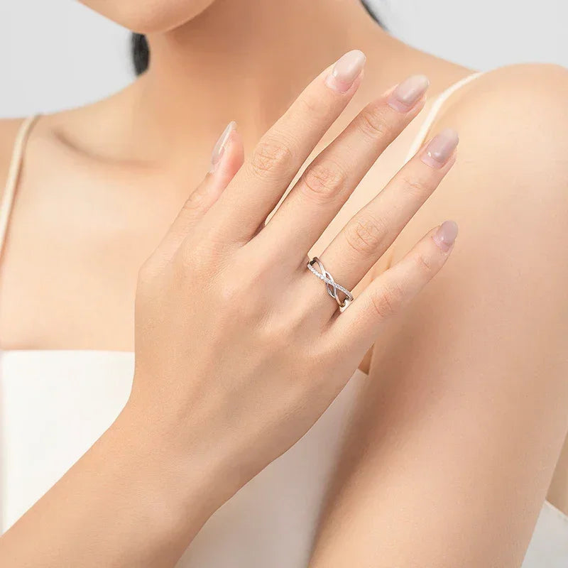 Woman wearing elegant twisted 925 silver ring on finger, minimalist jewelry style