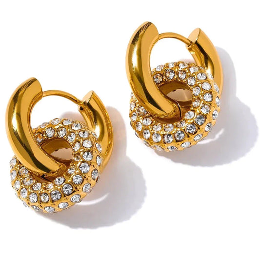 Gold-plated hoop earrings with pavé clear crystals in a circular knot design on white background