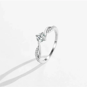 Silver ring with a diamond on a white background