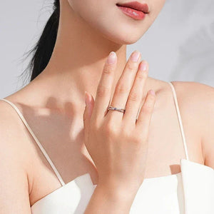 Close-up of a woman wearing Lilac Luxe Zirconia Band - TM & Co. Jewels on her finger against a neutral background.