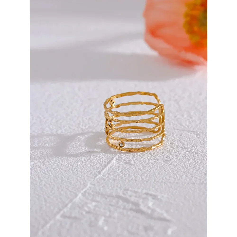 18K gold-plated textured ring with stacked band design on white surface