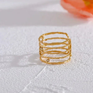 18K gold-plated textured ring with stacked band design on white surface