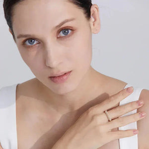 Woman in white dress wearing gold-plated silver ring, elegant jewelry for women