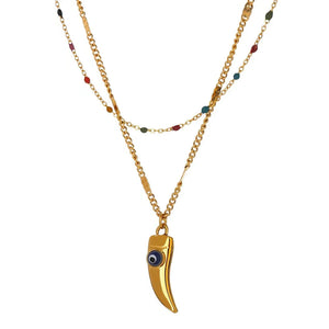 Gold necklace with a unique pendant on a white background