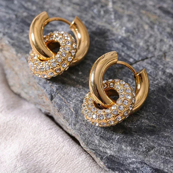 Gold-plated hoop earrings with sparkling crystal pavé, elegant everyday jewelry on stone