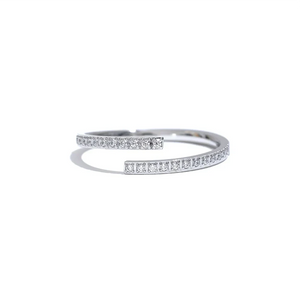 Gold and silver open rings with small crystals, minimalist jewelry on textured fabric