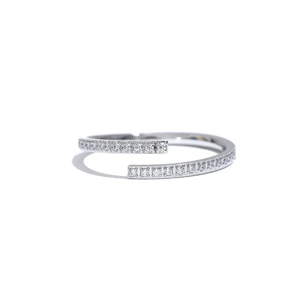 Gold and silver open rings with small crystals, minimalist jewelry on textured fabric