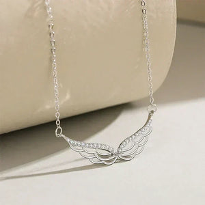 Silver necklace with a decorative pendant on a beige surface