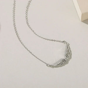 Silver necklace on a light gray background