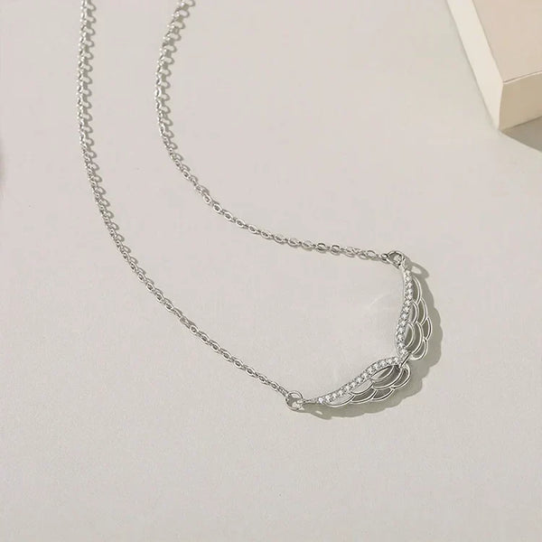 Silver necklace on a light gray background