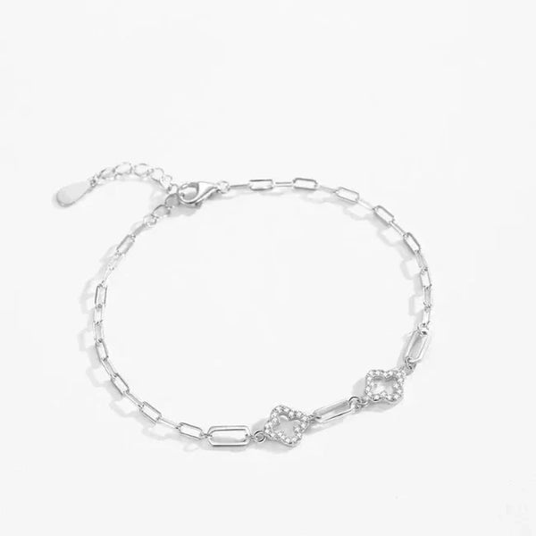 925 silver chain bracelet with geometric links and two heart-shaped pavé accents on white background