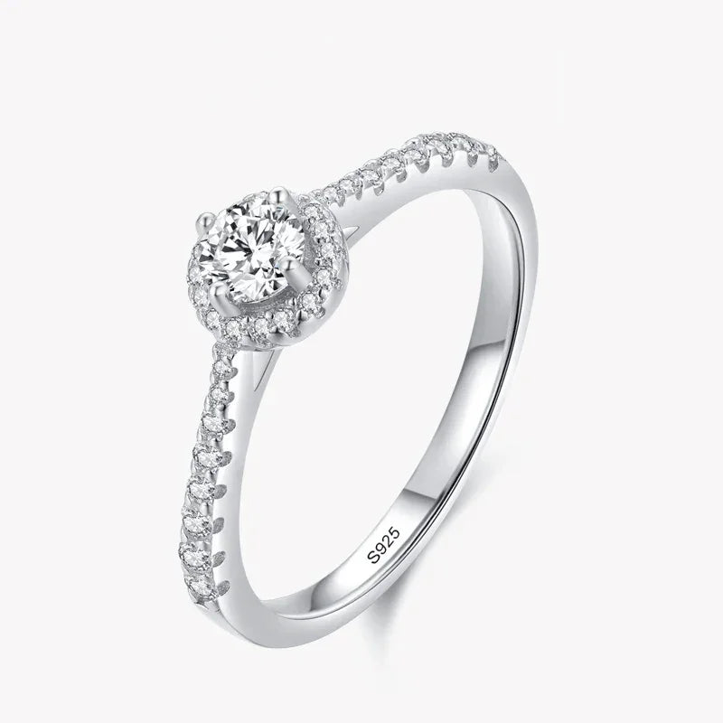 Sterling silver ring with round center cubic zirconia and pavé band on white background