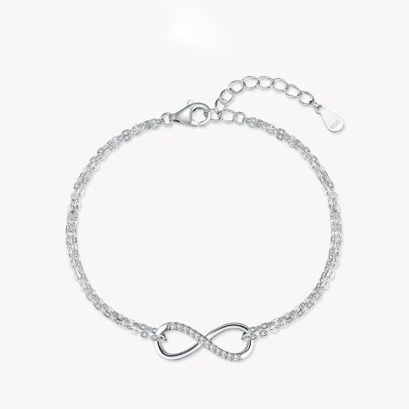 925 silver infinity bracelet with double chain and cubic zirconia accents on white background