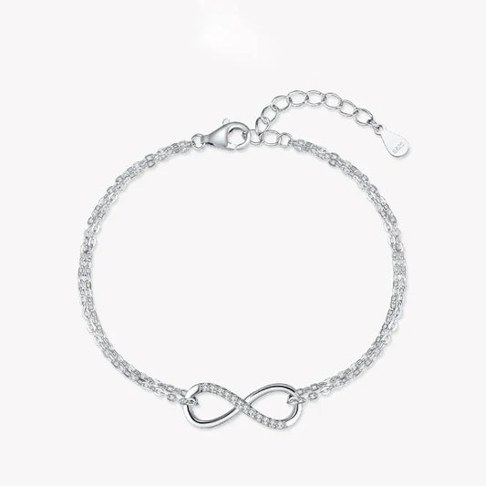 925 silver infinity bracelet with double chain and cubic zirconia accents on white background