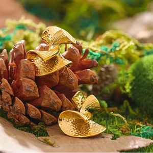 Gold leaf decoration on a pine cone with a natural background