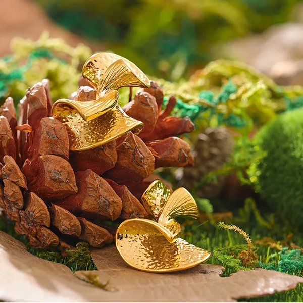 Gold leaf decoration on a pine cone with a natural background