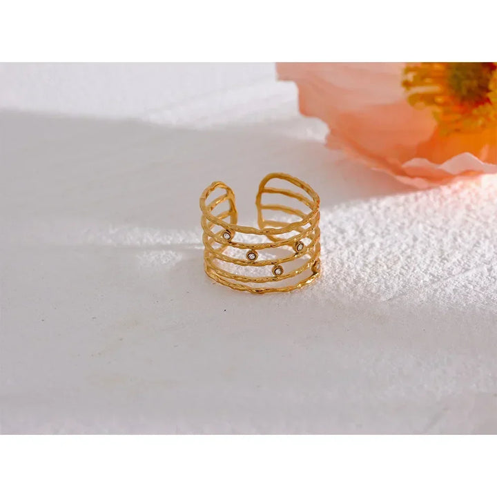 18K gold-plated open cuff ring with textured bands and small gemstone accents