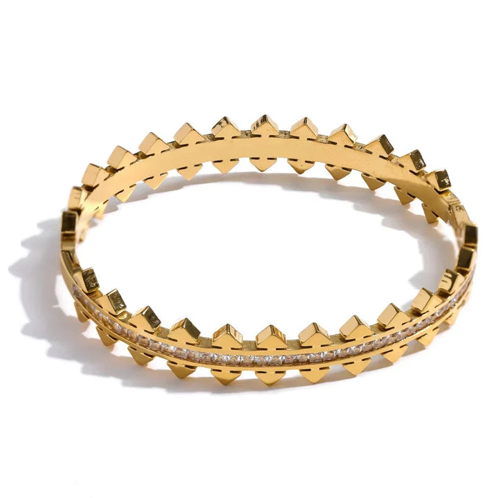 Gold bracelet with geometric design on a white background