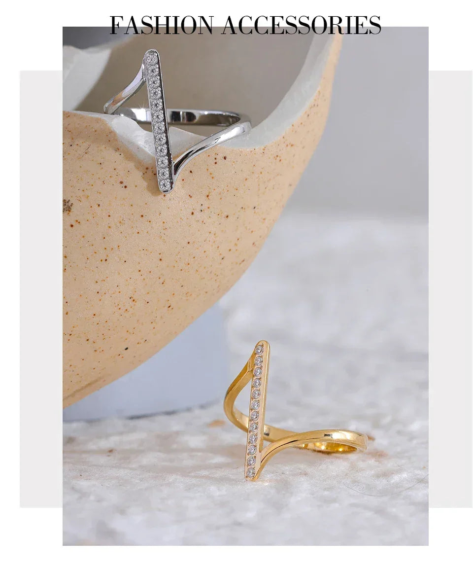 Gold and silver adjustable rings with vertical CZ accents on textured background