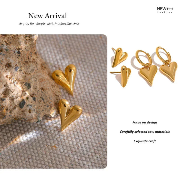 Gold heart-shaped earrings on a textured surface with 'New Arrival' text and brand name.