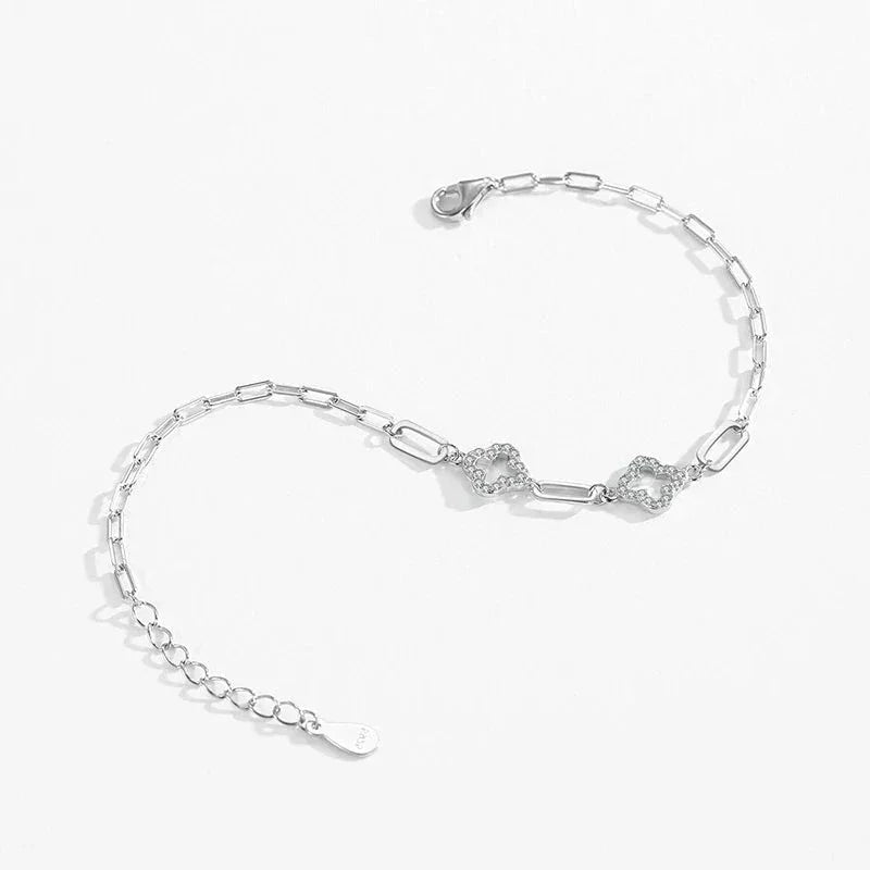 Sterling silver chain bracelet with heart-shaped links and adjustable clasp on white background