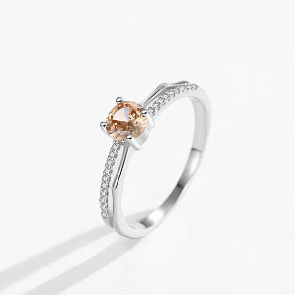 Silver ring with a peach-colored gemstone on a white background