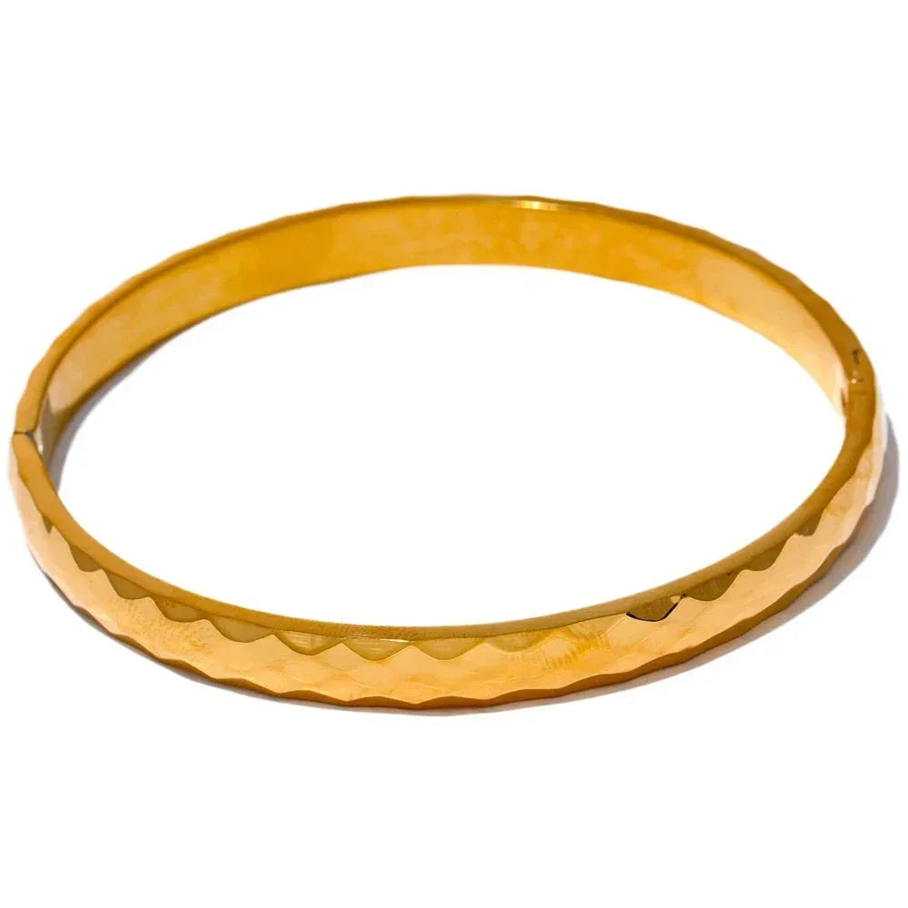 Gold-plated 925 silver bangle bracelet with a wavy textured pattern on a white background