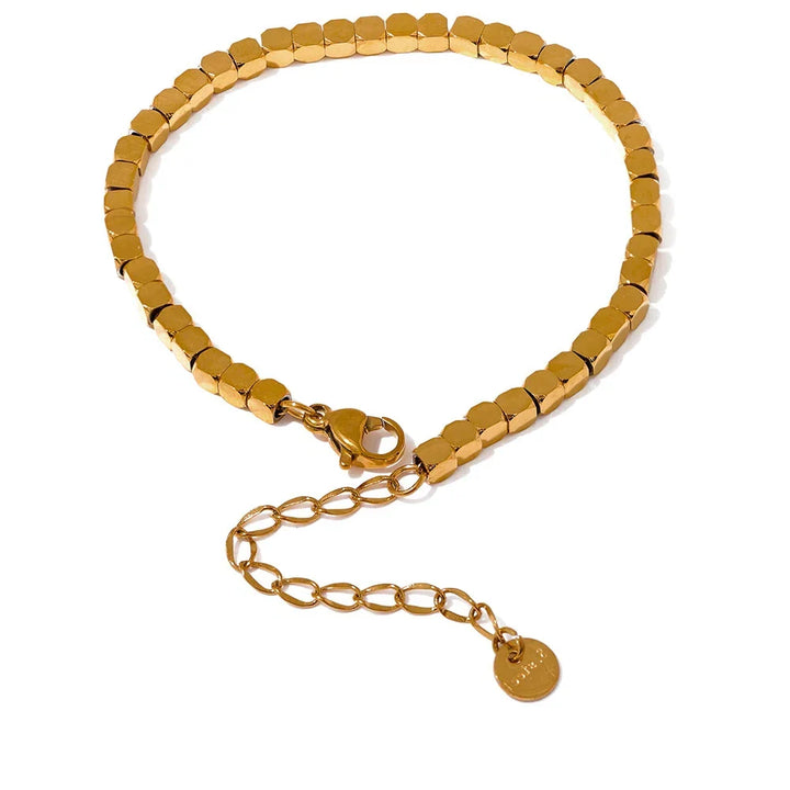 Gold beaded bracelet with a clasp on a white background.