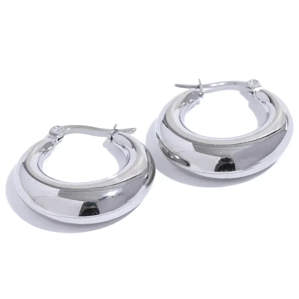 Pair of chunky 925 silver hoop earrings with a high-polish finish on white background