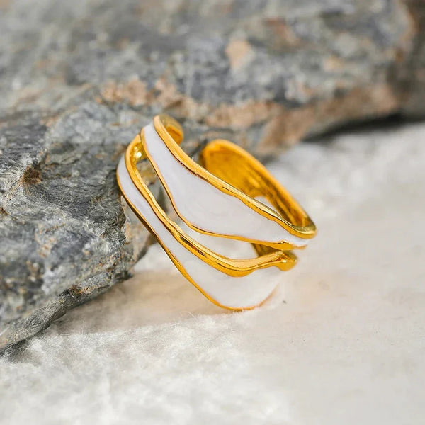 18K gold-plated adjustable ring with white enamel accents on a marble background