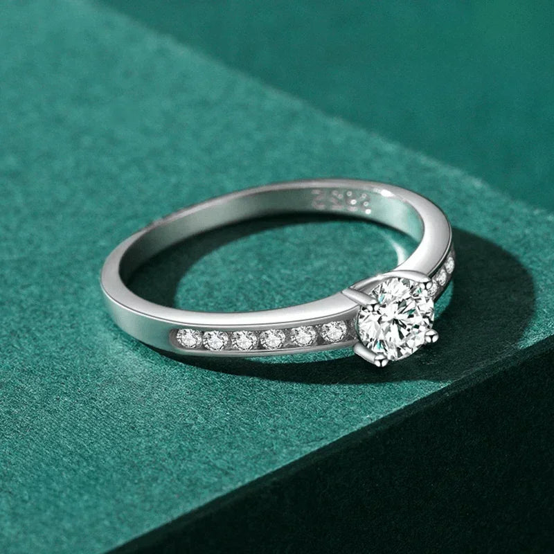 Elegant 925 silver ring with round center stone and pavé side stones on green background