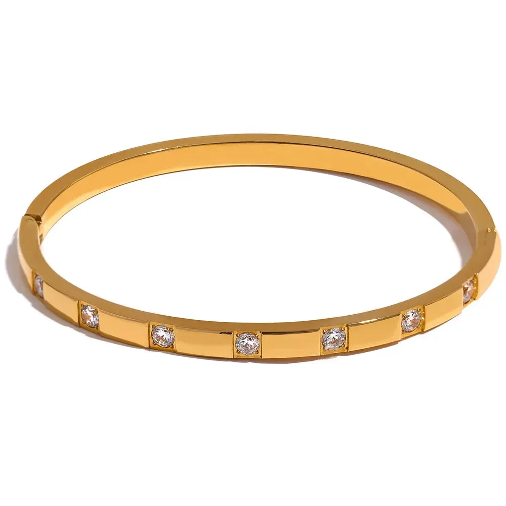 18K gold-plated bangle bracelet with round clear gemstones set in geometric pattern