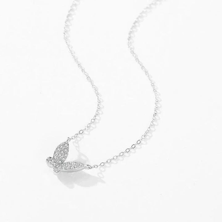 Silver butterfly necklace on a white background