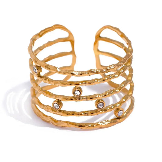 Textured 18K gold-plated cuff ring with open bands and clear crystal accents