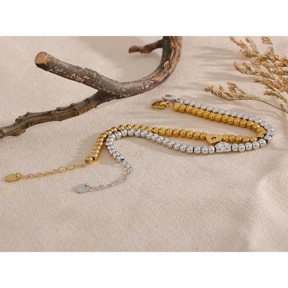 18K gold-plated and 925 silver beaded bracelets on beige fabric with natural accents