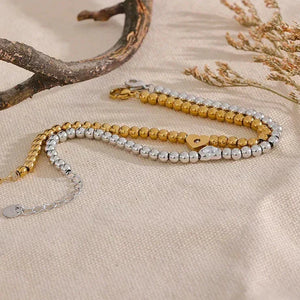 18K gold-plated and 925 silver beaded bracelets on beige fabric with natural accents