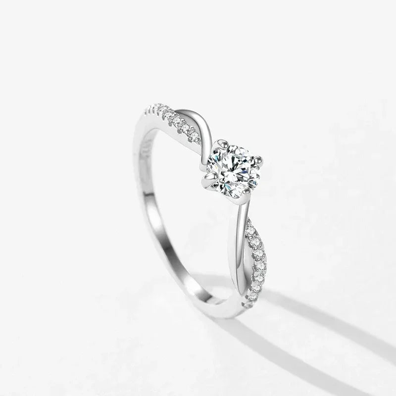 Sterling silver ring with round solitaire and pavé accent stones on twisted band