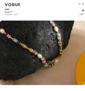 Colorful beaded necklace on a textured surface with 'Vogue' branding.-Nouveau Bohème Necklace - TM & CO. JEWELS 