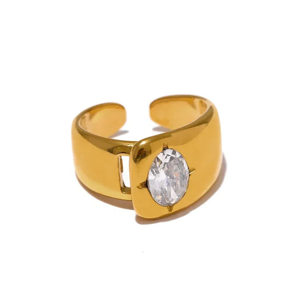 Gold ring with a clear gemstone on a white background