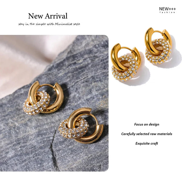 Gold-plated hoop earrings with crystal pavé, minimalist design on stone background