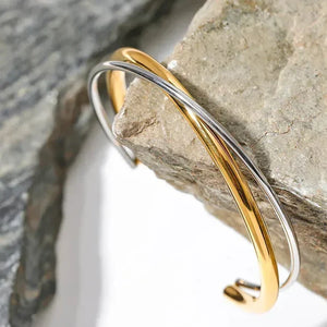 Elegant 925 silver and 18K gold-plated cuff bracelet on natural stone background