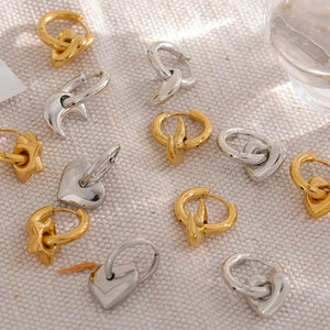 Astral Affection Hoops - TM & CO. JEWELS - Gold and silver hoop earrings on a textured surface.