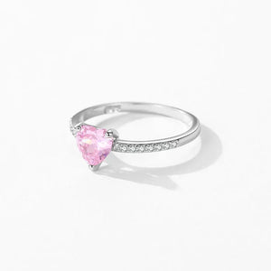 Silver ring with a pink heart-shaped gemstone on a white background