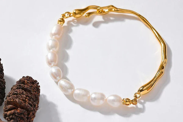 Pearl bracelet with gold clasp on a white background