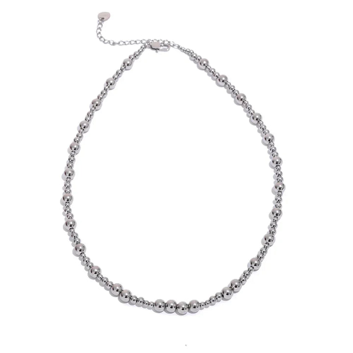 Silver beaded necklace on a white background